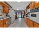 Traditional kitchen features wood cabinets, white appliances, and an adjacent dining area at 4670 Sundridge Trl, Fairburn, GA 30213