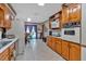 Traditional kitchen features wood cabinets, updated appliances, and dining area at 4670 Sundridge Trl, Fairburn, GA 30213