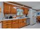 Traditional kitchen with wood cabinets, stainless steel appliances, and tiled floor at 4670 Sundridge Trl, Fairburn, GA 30213