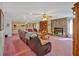Spacious living room featuring a stone fireplace, built-in shelving, and comfortable seating arrangements at 4670 Sundridge Trl, Fairburn, GA 30213