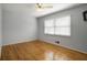 This bedroom has hardwood floors, a ceiling fan and a window at 2223 Jay Se Ln, Smyrna, GA 30080