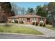 Charming single-story brick home with manicured lawn and mature trees, plus a long driveaway at 2223 Jay Se Ln, Smyrna, GA 30080