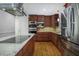 A modern kitchen with an island, wooden cabinets, and stainless steel appliances at 2223 Jay Se Ln, Smyrna, GA 30080