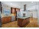 Bright kitchen with stainless steel appliances, wooden cabinets, and an island with granite countertop at 2223 Jay Se Ln, Smyrna, GA 30080