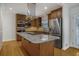 Updated kitchen with stainless steel appliances, wooden cabinets, and an island at 2223 Jay Se Ln, Smyrna, GA 30080