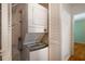 Efficient laundry area with stacked washer and dryer, and storage shelving at 2223 Jay Se Ln, Smyrna, GA 30080