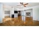 Open living room with hardwood floors, fireplace, ceiling fan, and view to dining and kitchen at 2223 Jay Se Ln, Smyrna, GA 30080