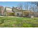 Well-kept green lawn in back with covered patio and a black chain-link fence at 302 Vinson Mountain Loop, Rockmart, GA 30153