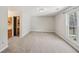 Bedroom with neutral carpet and window, with access to a sink area at 302 Vinson Mountain Loop, Rockmart, GA 30153
