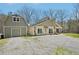 Side view of the house and detached garage with stone facade and ample parking space at 302 Vinson Mountain Loop, Rockmart, GA 30153