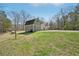 A quaint, two-story home with a rustic barn, set on a large grassy lot with natural surroundings at 302 Vinson Mountain Loop, Rockmart, GA 30153