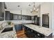 Modern kitchen with granite countertops, stainless steel appliances, and black cabinets at 302 Vinson Mountain Loop, Rockmart, GA 30153