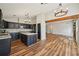 Spacious kitchen featuring dark cabinets, granite countertops, an island, and wood floors at 302 Vinson Mountain Loop, Rockmart, GA 30153