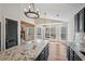 An eat-in kitchen with an island, granite countertops, wood beam accent, and views of nature at 302 Vinson Mountain Loop, Rockmart, GA 30153