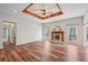 Spacious living room featuring a decorative ceiling, fireplace, and wood-look flooring at 302 Vinson Mountain Loop, Rockmart, GA 30153