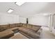 Spacious living room with plush brown sectional couch, white walls, and ample lighting at 302 Vinson Mountain Loop, Rockmart, GA 30153