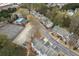 Community aerial view featuring townhouses, a pool, tennis courts, and lush greenery at 5980 Eagle Tiff Ln, Sugar Hill, GA 30518