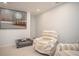 Bonus room with neutral color walls and carpet, seating, and an attractive print at 5980 Eagle Tiff Ln, Sugar Hill, GA 30518