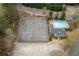 Aerial shot showcasing community tennis courts and a sparkling swimming pool with lounge chairs at 5980 Eagle Tiff Ln, Sugar Hill, GA 30518
