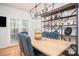 Bright dining room featuring a wood table, shelving, and plenty of natural light from the windows at 5980 Eagle Tiff Ln, Sugar Hill, GA 30518