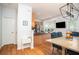 Open kitchen area with stainless steel appliances and a dining area with a chandelier at 5980 Eagle Tiff Ln, Sugar Hill, GA 30518