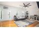 Bright living room features a ceiling fan, hardwood floors, and lots of natural light at 5980 Eagle Tiff Ln, Sugar Hill, GA 30518
