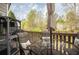 Outdoor patio with seating for four, a neutral color umbrella, and animal enclosure at 5980 Eagle Tiff Ln, Sugar Hill, GA 30518