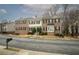 A line of brick townhouses with black shutters, landscaping, and visible street address at 5980 Eagle Tiff Ln, Sugar Hill, GA 30518