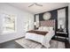 Bedroom with dark accent wall, large windows, and stylish decor creating a cozy retreat at 1821 Huntington Hills Nw Ln, Atlanta, GA 30309