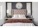Bedroom with tufted headboard, stylish lamps, and dark accent wall create an inviting and sophisticated space at 1821 Huntington Hills Nw Ln, Atlanta, GA 30309