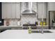 Modern kitchen featuring stainless steel appliances, white countertops, and stylish gray cabinetry for a sleek design at 1821 Huntington Hills Nw Ln, Atlanta, GA 30309