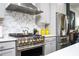Close-up of a modern kitchen showcasing high-end stainless steel appliances, sleek countertops, and stylish backsplash at 1821 Huntington Hills Nw Ln, Atlanta, GA 30309