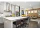 Bright, open kitchen features a large island with seating, stainless steel appliances, and stylish gray cabinetry at 1821 Huntington Hills Nw Ln, Atlanta, GA 30309