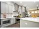 Contemporary kitchen featuring stainless steel appliances, a large island, and elegant gray cabinetry at 1821 Huntington Hills Nw Ln, Atlanta, GA 30309
