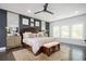 Bright main bedroom features a ceiling fan, decorative rug, and large windows for ample natural light at 1821 Huntington Hills Nw Ln, Atlanta, GA 30309