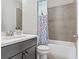 Bathroom with white vanity, toilet, bathtub, and colorful shower curtain at 1922 Coal Pl, Atlanta, GA 30318