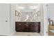 Bathroom vanity area with double sinks, dark cabinets, and light countertops at 1922 Coal Pl, Atlanta, GA 30318