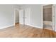 Neutral bedroom featuring hardwood floors and an en-suite bath at 1922 Coal Pl, Atlanta, GA 30318