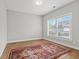 A cozy bedroom featuring hardwood floors and a bright window with natural light at 1922 Coal Pl, Atlanta, GA 30318