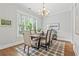 Bright dining room with a modern chandelier, large windows, and seating for six at 1922 Coal Pl, Atlanta, GA 30318