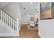 Elegant entryway featuring hardwood floors, a staircase with white railings and a view into the living room at 1922 Coal Pl, Atlanta, GA 30318