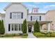 Charming two-story home with white painted brick, black shutters, and a landscaped front yard at 1922 Coal Pl, Atlanta, GA 30318