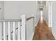 Hallway with hardwood flooring and white railing at 1922 Coal Pl, Atlanta, GA 30318