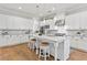 Modern kitchen featuring white cabinets, stainless steel appliances, a large island, and hardwood floors at 1922 Coal Pl, Atlanta, GA 30318
