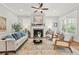 Cozy living room with fireplace, ceiling fan, neutral color palette, and ample natural light at 1922 Coal Pl, Atlanta, GA 30318