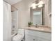 Well-lit bathroom featuring a shower-tub combo, white vanity, and a neutral color scheme at 2306 Queen Anne Ct, Atlanta, GA 30350