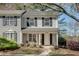 Charming two-story home with a well-manicured front yard and welcoming covered porch at 2306 Queen Anne Ct, Atlanta, GA 30350