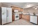 Traditional kitchen featuring tile floors, white appliances and light brown wood cabinetry at 2306 Queen Anne Ct, Atlanta, GA 30350