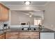 Kitchen featuring granite countertops, light brown cabinetry, and open view into the living area at 2306 Queen Anne Ct, Atlanta, GA 30350
