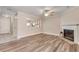 Living room boasts hardwood floors, a fireplace, and view into the kitchen at 2306 Queen Anne Ct, Atlanta, GA 30350